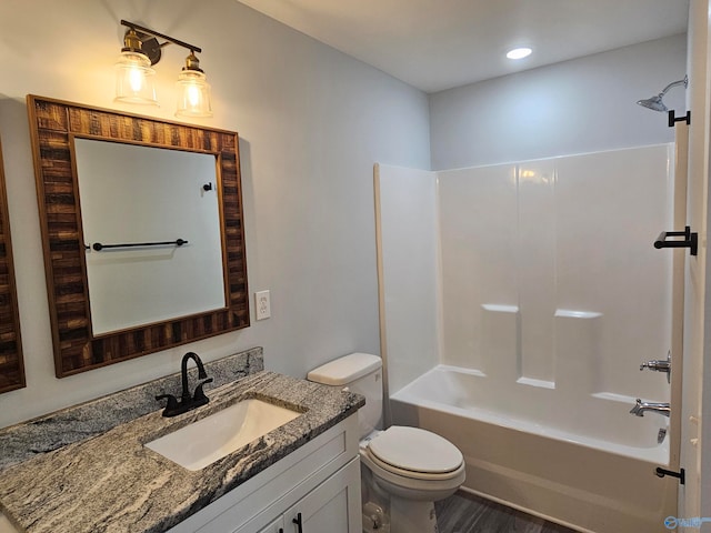 full bathroom with toilet, vanity, and  shower combination