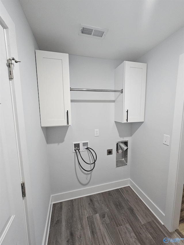 washroom with washer hookup, cabinet space, visible vents, and baseboards