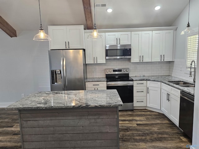 kitchen featuring a sink, visible vents, beam ceiling, and appliances with stainless steel finishes