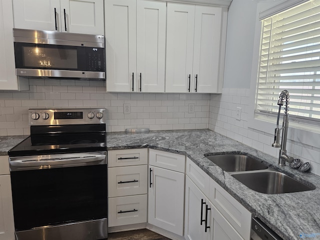 kitchen with white cabinetry, appliances with stainless steel finishes, and a sink