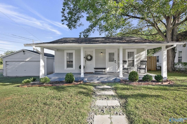 view of front facade featuring a garage, an outdoor structure, a front lawn, and covered porch