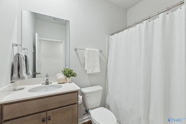 bathroom with vanity, toilet, and curtained shower