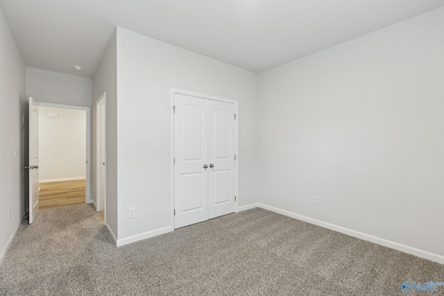 unfurnished bedroom with a closet and carpet flooring