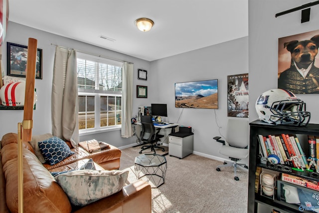 carpeted office space featuring visible vents and baseboards