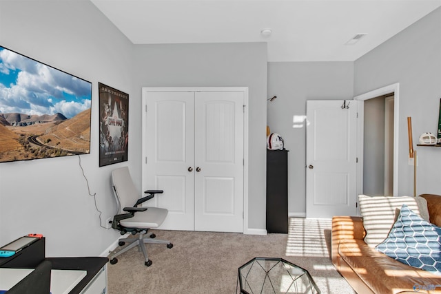 carpeted home office featuring baseboards