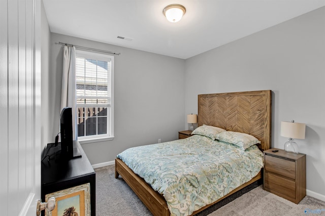 carpeted bedroom with visible vents and baseboards
