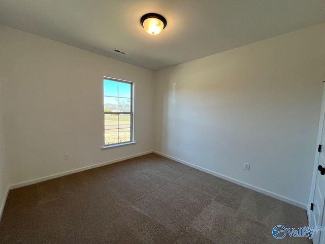 spare room featuring carpet