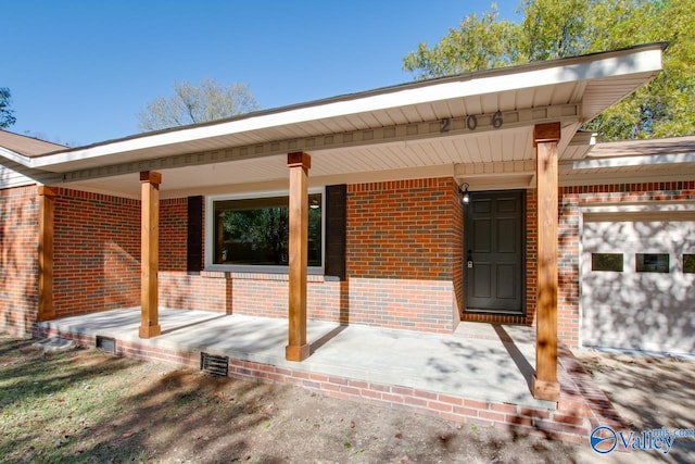 back of house featuring a garage and a porch