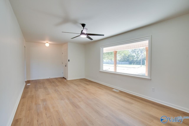 unfurnished room with ceiling fan and light wood-type flooring