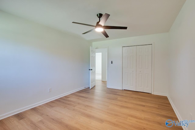 unfurnished bedroom featuring ceiling fan, light hardwood / wood-style floors, and a closet