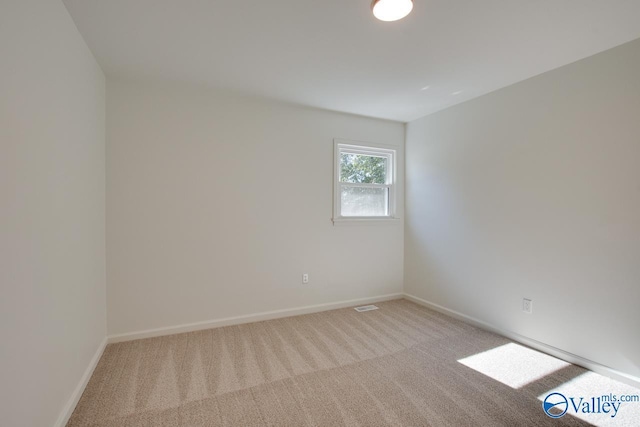 spare room with light carpet