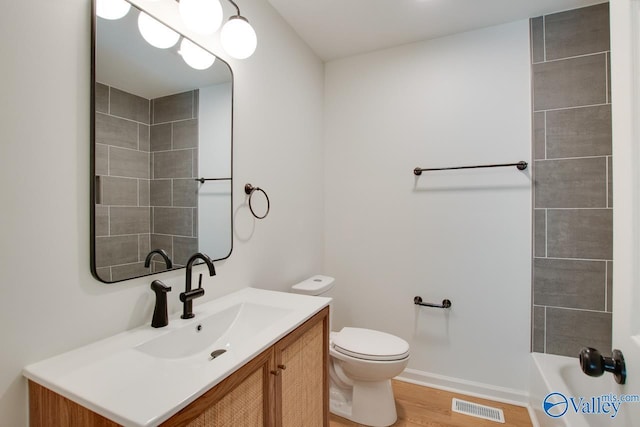 full bathroom featuring hardwood / wood-style flooring, vanity, toilet, and independent shower and bath