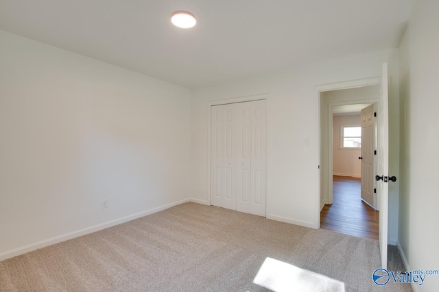 unfurnished bedroom with a closet and carpet flooring