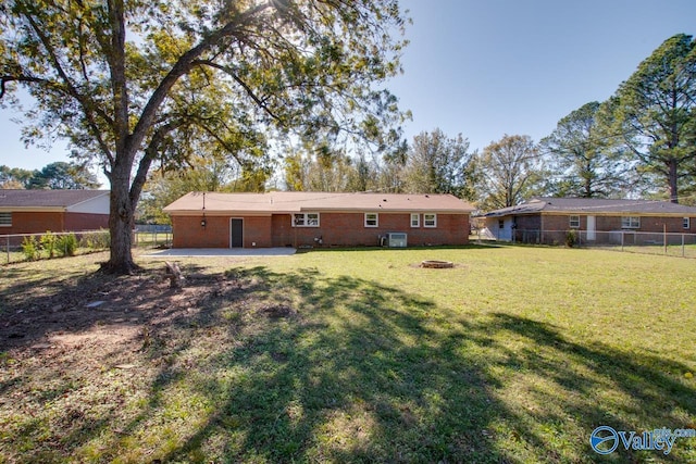 rear view of house featuring a lawn