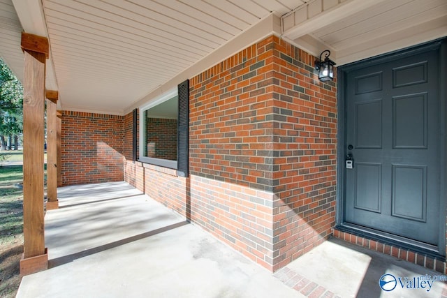 view of exterior entry with covered porch