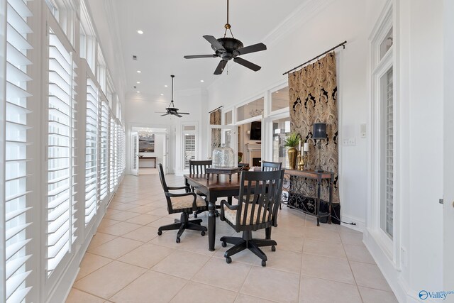 dining room featuring ceiling fan, light tile patterned floors, a high ceiling, recessed lighting, and ornamental molding