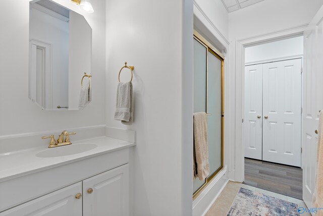 full bathroom featuring a shower stall and vanity