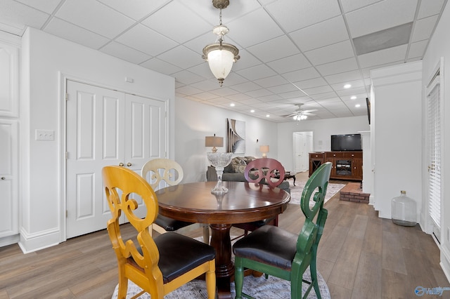 dining room featuring wood finished floors, a paneled ceiling, a ceiling fan, and recessed lighting