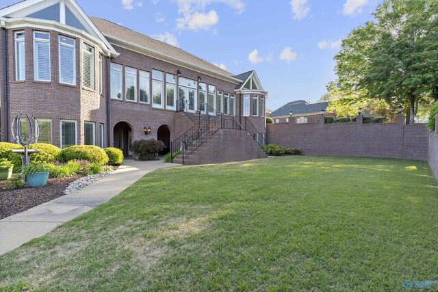 view of front facade with brick siding and stairs