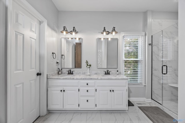bathroom with a sink, marble finish floor, and a marble finish shower