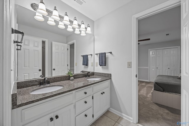 bathroom with visible vents, a sink, baseboards, and double vanity