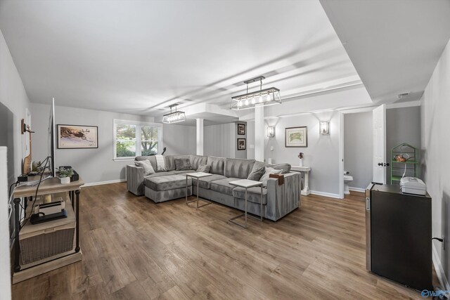 living room featuring baseboards and wood finished floors