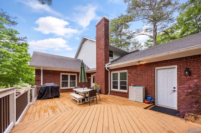 deck featuring grilling area and outdoor dining space