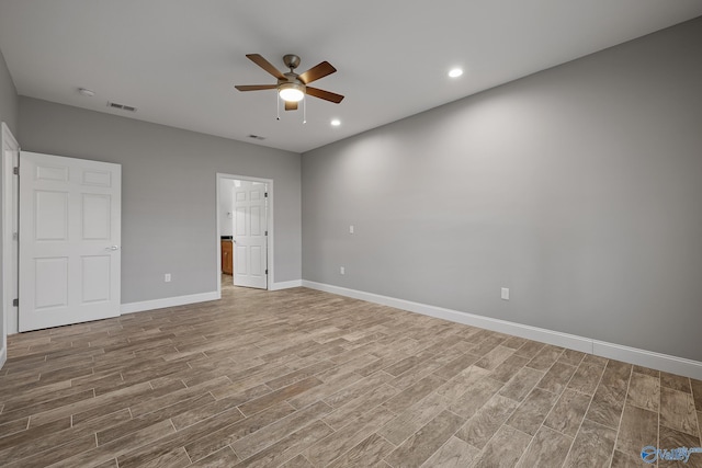 unfurnished bedroom featuring visible vents, baseboards, ensuite bathroom, recessed lighting, and wood finished floors