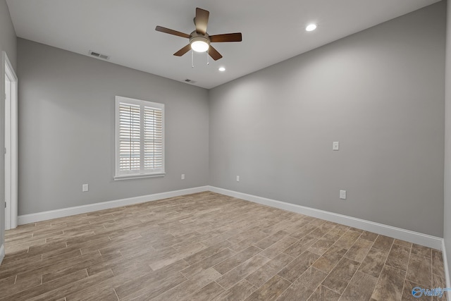 spare room featuring baseboards, recessed lighting, a ceiling fan, visible vents, and wood finished floors