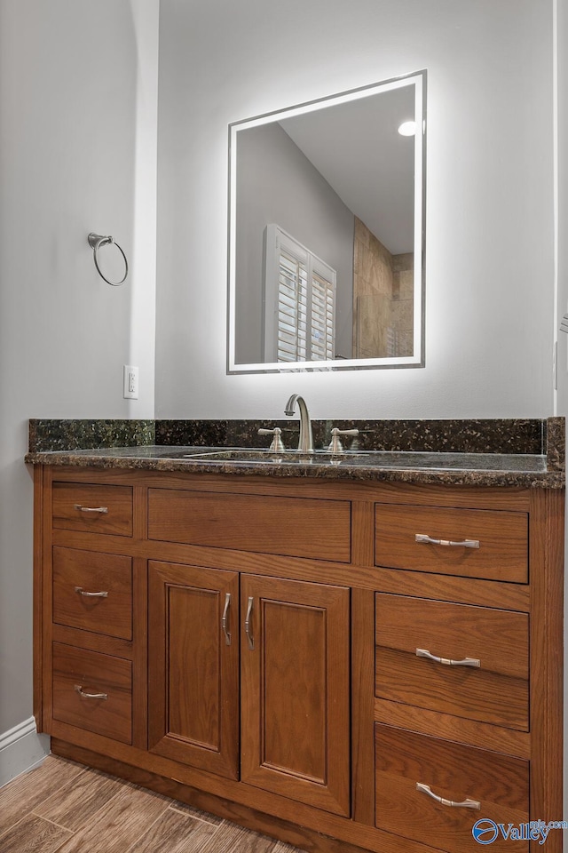 bathroom with vanity and wood finished floors
