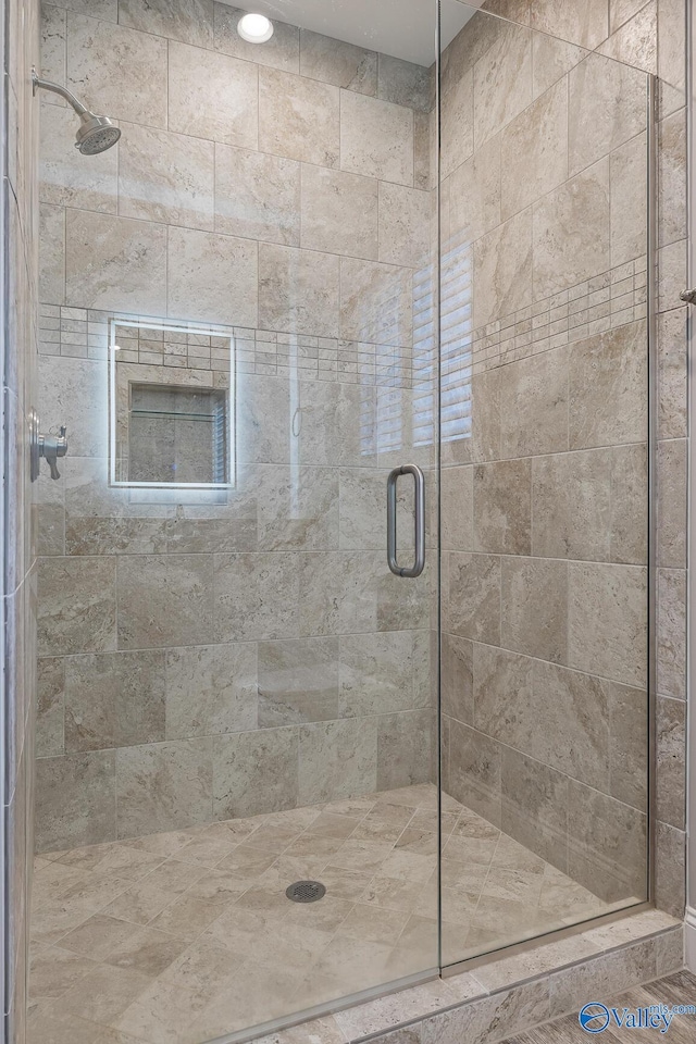 full bath featuring a shower stall