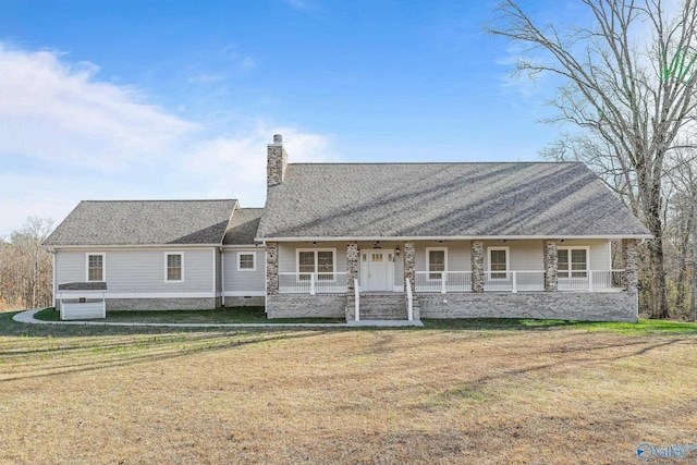 view of front of property with a shingled roof, a chimney, covered porch, and a front lawn