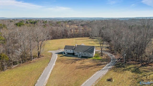birds eye view of property featuring a rural view and a view of trees