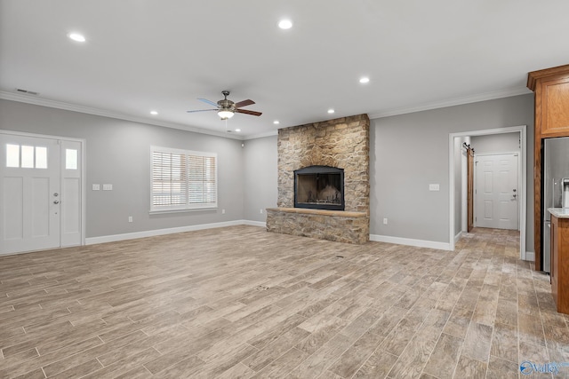 unfurnished living room with baseboards, light wood-type flooring, crown molding, visible vents, and ceiling fan
