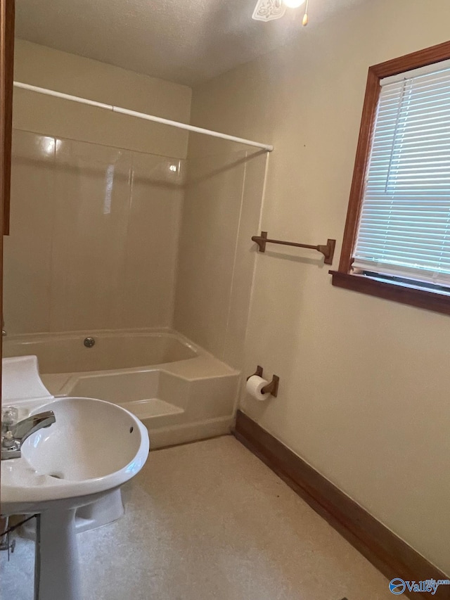 bathroom with baseboards and shower / washtub combination