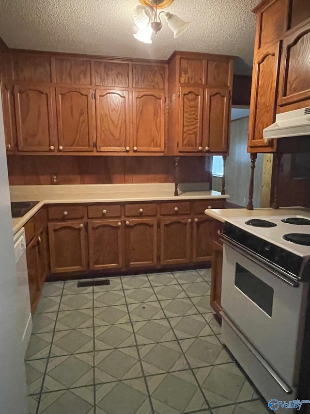 kitchen featuring white electric range oven, light floors, light countertops, under cabinet range hood, and brown cabinets