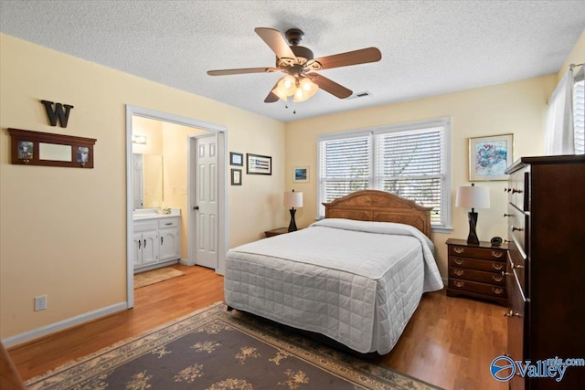 bedroom with wood-type flooring, a textured ceiling, and ceiling fan