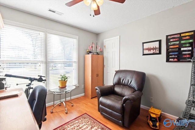 office area featuring plenty of natural light, ceiling fan, and a textured ceiling