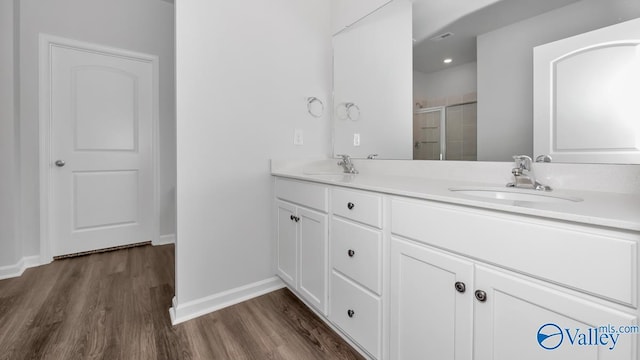 304 Wraywood Rd, Huntsville, AL 35810 - full bathroom featuring a stall shower, wood finished floors, double vanity, and baseboards