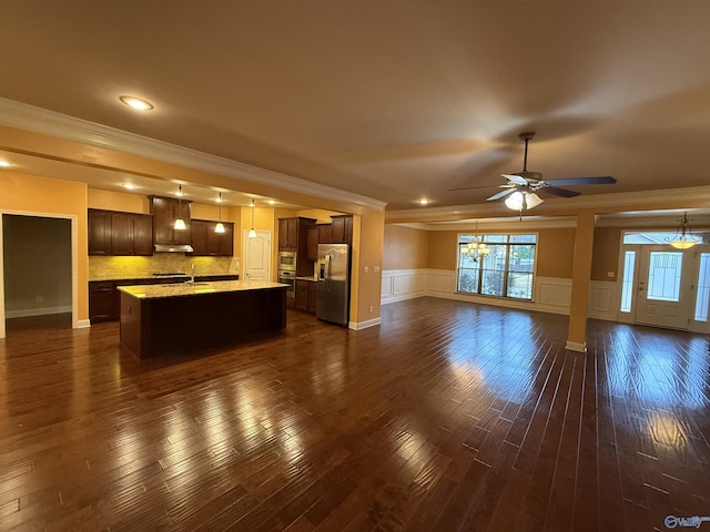 unfurnished living room featuring dark hardwood / wood-style floors, ceiling fan, ornamental molding, and sink