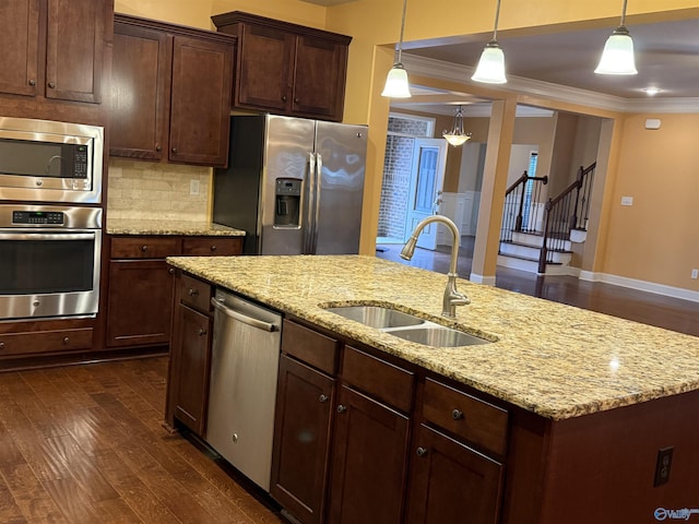 kitchen featuring sink, dark hardwood / wood-style floors, crown molding, pendant lighting, and appliances with stainless steel finishes