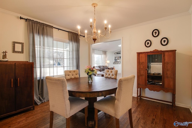 dining area featuring crown molding, dark hardwood / wood-style floors, and a chandelier