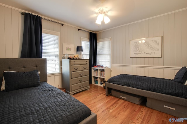 bedroom with ornamental molding and light hardwood / wood-style flooring