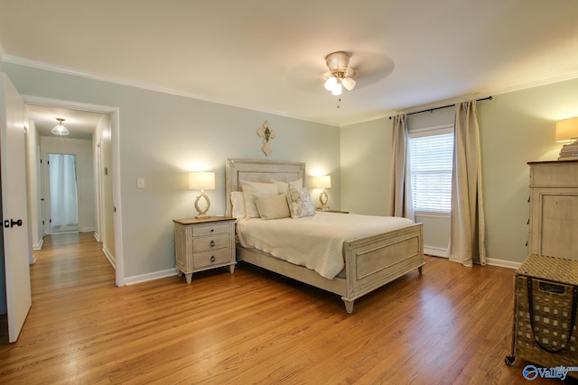 bedroom with crown molding, light hardwood / wood-style floors, and ceiling fan