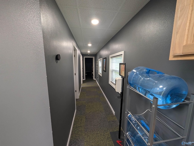 hallway with baseboards, a textured wall, carpet, and recessed lighting
