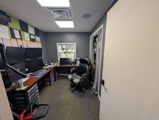 carpeted home office featuring a drop ceiling