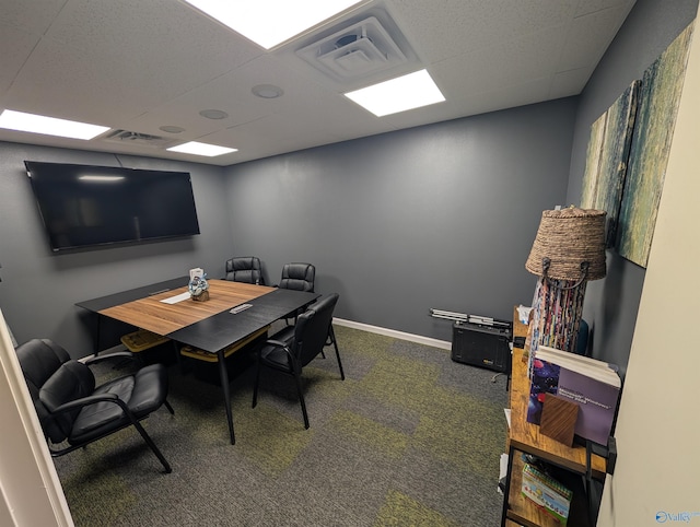 office space featuring carpet floors, baseboards, and visible vents