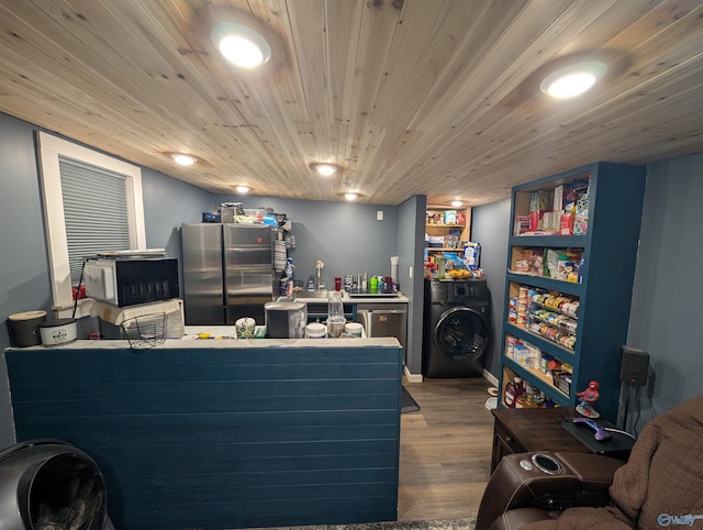 miscellaneous room with washer / dryer and wood finished floors