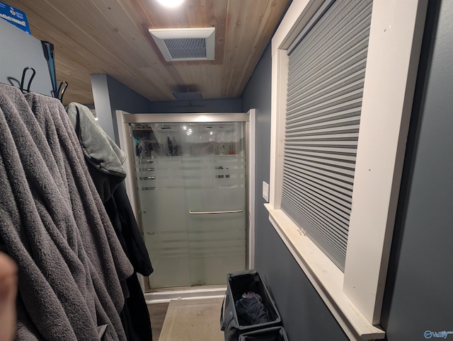 full bath with visible vents, wood ceiling, wood finished floors, and a shower stall