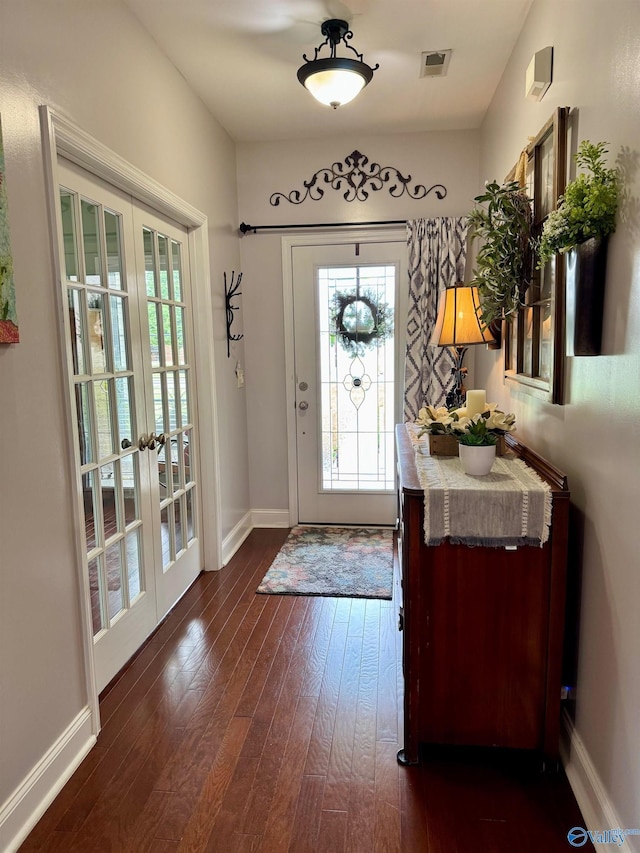 entryway featuring dark wood finished floors, visible vents, baseboards, and french doors